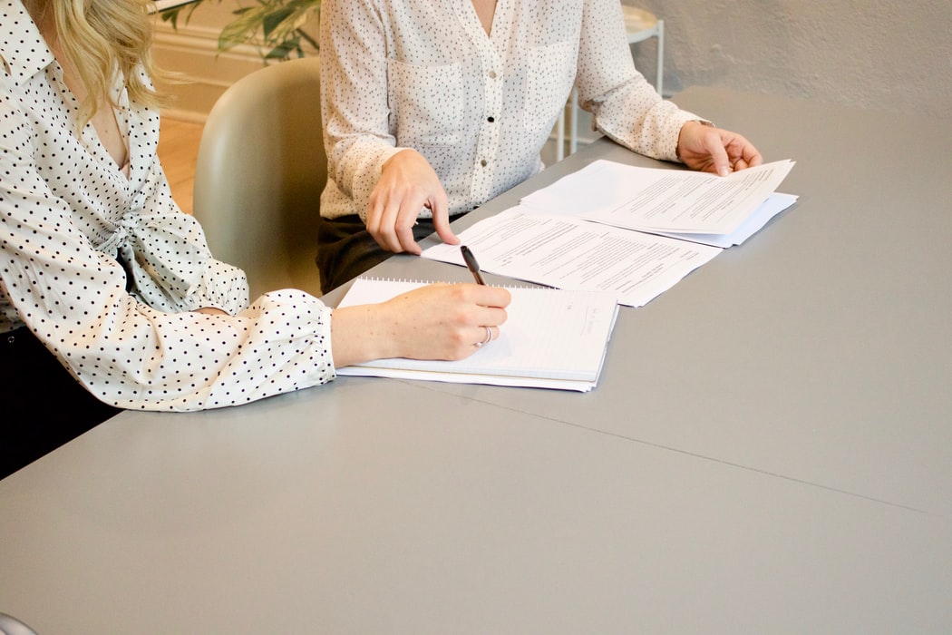 two women filling out paperwork